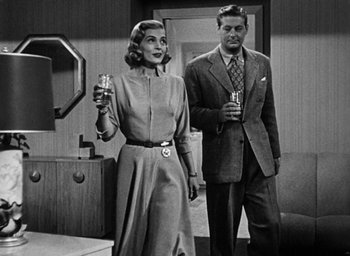Movie still from “Too Late for Tears” (1949), directed by Byron Haskin – A man and a woman standing next to each other holding drinks; Medium shot, Over the shoulder angle