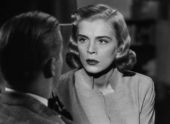 Movie still from “Too Late for Tears” (1949), directed by Byron Haskin – An old black and white photo of a woman looking in the mirror; Close Up shot, Over the shoulder angle