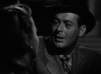 Movie still from “Too Late for Tears” (1949), directed by Byron Haskin – An old photo of a man and a woman in a car; Close Up shot, Over the shoulder angle