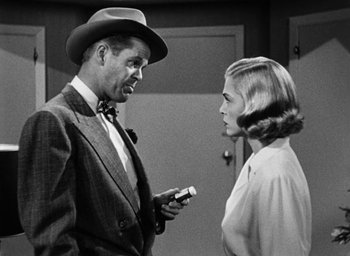Movie still from “Too Late for Tears” (1949), directed by Byron Haskin – A man and a woman talking to each other; Medium shot, Over the shoulder angle
