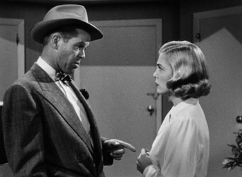 Movie still from “Too Late for Tears” (1949), directed by Byron Haskin – A man and a woman are talking to each other; Medium shot, Over the shoulder angle