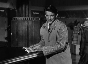 Movie still from “Too Late for Tears” (1949), directed by Byron Haskin – A black and white photo of a man in a plaid jacket; Medium shot, Low angle