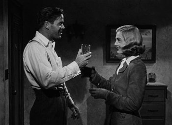 Movie still from “Too Late for Tears” (1949), directed by Byron Haskin – A man and a woman holding a wine glass; Medium shot, Low angle