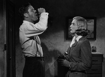 Movie still from “Too Late for Tears” (1949), directed by Byron Haskin – A man and a woman standing next to each other in a room; Medium shot, Low angle