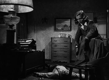 Movie still from “Too Late for Tears” (1949), directed by Byron Haskin – A woman standing over a man lying on the ground; Medium shot, High angle