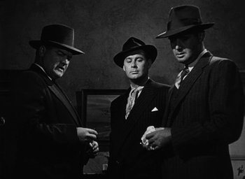 Movie still from “Too Late for Tears” (1949), directed by Byron Haskin – A group of men standing next to each other wearing hats; Medium shot, Low angle