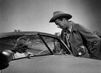 Movie still from “Too Late for Tears” (1949), directed by Byron Haskin – A man and a woman sitting in the back seat of a car; Medium shot, Over the shoulder angle