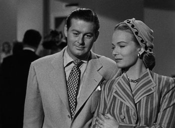 Movie still from “Too Late for Tears” (1949), directed by Byron Haskin – A man and a woman standing next to each other; Medium shot, Low angle