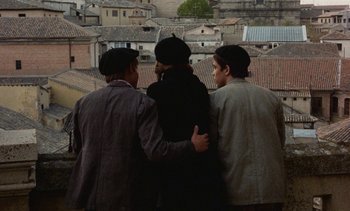 Movie still from “Tristana” (1970), directed by Luis Buñuel – A group of men standing next to each other; Medium shot, High angle
