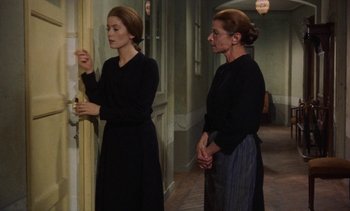 Movie still from “Tristana” (1970), directed by Luis Buñuel – Two women standing in front of a door; Medium shot, Over the shoulder angle