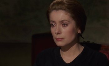 Movie still from “Tristana” (1970), directed by Luis Buñuel – A person wearing a black shirt; Close Up shot, Over the shoulder angle