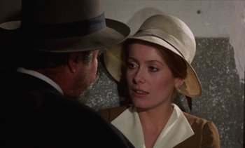 Movie still from “Tristana” (1970), directed by Luis Buñuel – A man and a woman wearing hats and talking to each other; Close Up shot, Over the shoulder angle