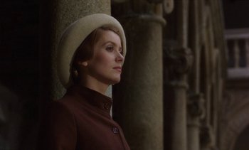 Movie still from “Tristana” (1970), directed by Luis Buñuel – A woman wearing a hat standing next to a pillar; Close Up shot, Low angle