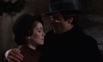 Movie still from “Tristana” (1970), directed by Luis Buñuel – A man and a woman are standing together in the dark; Close Up shot, Low angle