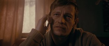 Movie still from “Wild Bill” (2011), directed by Dexter Fletcher – A person talking on a cell phone; Close Up shot, Over the shoulder angle