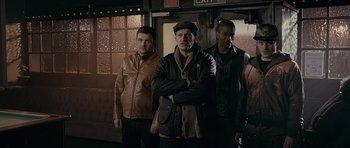 Movie still from “Wild Bill” (2011), directed by Dexter Fletcher – A group of men standing next to each other in a room; Medium shot, Low angle