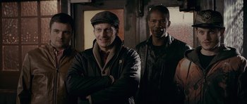 Movie still from “Wild Bill” (2011), directed by Dexter Fletcher – Two men and a woman standing next to each other; Medium shot, Low angle