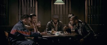 Movie still from “Wild Bill” (2011), directed by Dexter Fletcher – A group of men sitting at a table drinking beer; Medium shot, High angle