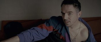 Movie still from “Wild Bill” (2011), directed by Dexter Fletcher – A person sitting on a couch; Close Up shot, Over the shoulder angle