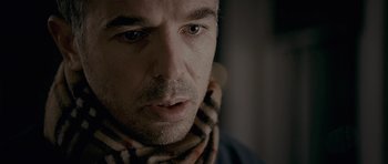 Movie still from “Wild Bill” (2011), directed by Dexter Fletcher – A person wearing a scarf; Close Up shot, Over the shoulder angle