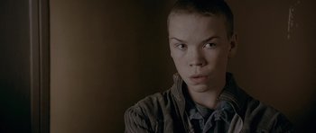 Movie still from “Wild Bill” (2011), directed by Dexter Fletcher – A young man with a shaved head looks into the camera; Close Up shot, High angle