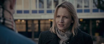 Movie still from “Wild Bill” (2011), directed by Dexter Fletcher – A person wearing a jacket and a scarf; Close Up shot, Over the shoulder angle