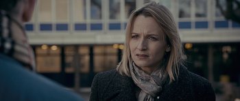 Movie still from “Wild Bill” (2011), directed by Dexter Fletcher – A person wearing a jacket and a scarf; Close Up shot, Over the shoulder angle