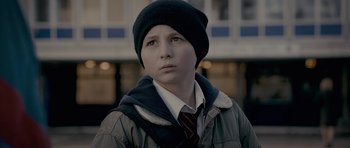 Movie still from “Wild Bill” (2011), directed by Dexter Fletcher – A young boy wearing a black hat and a jacket; Close Up shot, Low angle