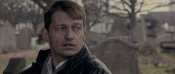 Movie still from “Wild Bill” (2011), directed by Dexter Fletcher – A person wearing a leather jacket; Close Up shot, Over the shoulder angle