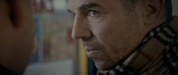 Movie still from “Wild Bill” (2011), directed by Dexter Fletcher – A man's face with a scarf around his neck; Extreme Close Up shot, Low angle