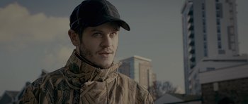 Movie still from “Wild Bill” (2011), directed by Dexter Fletcher – A person wearing a hat and a jacket; Close Up shot, Over the shoulder angle