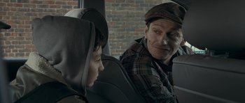 Movie still from “Wild Bill” (2011), directed by Dexter Fletcher – A man sitting next to a boy in the back of a car; Close Up shot, Over the shoulder angle