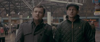Movie still from “Wild Bill” (2011), directed by Dexter Fletcher – A couple of men standing next to each other; Close Up shot, Low angle