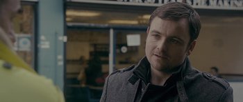 Movie still from “Wild Bill” (2011), directed by Dexter Fletcher – A person wearing a jacket; Close Up shot, Over the shoulder angle