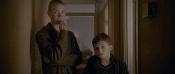 Movie still from “Wild Bill” (2011), directed by Dexter Fletcher – Two young boys are posing for a picture; Medium shot, Low angle