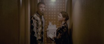 Movie still from “Wild Bill” (2011), directed by Dexter Fletcher – A man and a woman standing next to each other in a bathroom; Medium shot, Low angle