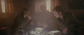 Movie still from “Wild Bill” (2011), directed by Dexter Fletcher – A group of people sitting around a table; Medium shot, Low angle