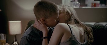 Movie still from “Wild Bill” (2011), directed by Dexter Fletcher – A boy and a girl are kissing each other; Close Up shot, Over the shoulder angle