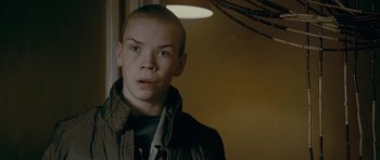 Movie still from “Wild Bill” (2011), directed by Dexter Fletcher – A young man with a shaved head is looking at the camera; Close Up shot, Over the shoulder angle