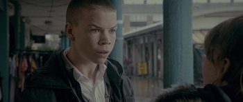 Movie still from “Wild Bill” (2011), directed by Dexter Fletcher – A man with a shaved head is standing outside; Close Up shot, Over the shoulder angle