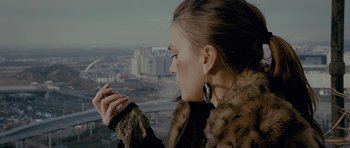 Movie still from “Wild Bill” (2011), directed by Dexter Fletcher – A woman in a fur coat looking out of a window; Close Up shot, Low angle