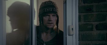 Movie still from “Wild Bill” (2011), directed by Dexter Fletcher – A man wearing a hat standing in front of an open door; Close Up shot, Low angle