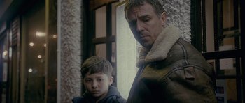 Movie still from “Wild Bill” (2011), directed by Dexter Fletcher – A man and a boy standing next to each other; Close Up shot, Over the shoulder angle
