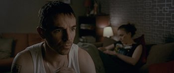 Movie still from “Wild Bill” (2011), directed by Dexter Fletcher – A person sitting on a couch; Close Up shot, Over the shoulder angle