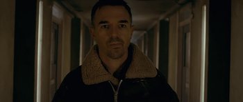 Movie still from “Wild Bill” (2011), directed by Dexter Fletcher – A person wearing a jacket in a dark room; Close Up shot, Low angle