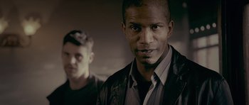 Movie still from “Wild Bill” (2011), directed by Dexter Fletcher – A man in a black shirt and a man in a black jacket; Close Up shot, Low angle