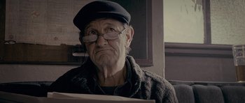 Movie still from “Wild Bill” (2011), directed by Dexter Fletcher – An old man wearing glasses and a hat; Close Up shot, Low angle