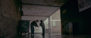 Movie still from “Wild Bill” (2011), directed by Dexter Fletcher – A man and a boy playing a game with a remote controller; Wide shot, Low angle