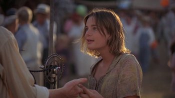 A woman talking to a man in front of a crowd