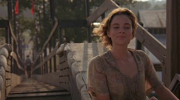 Movie still from “Wild Hearts Can't Be Broken” (1991), directed by Steve Miner – A woman standing in front of a wooden bridge; Close Up shot, Low angle